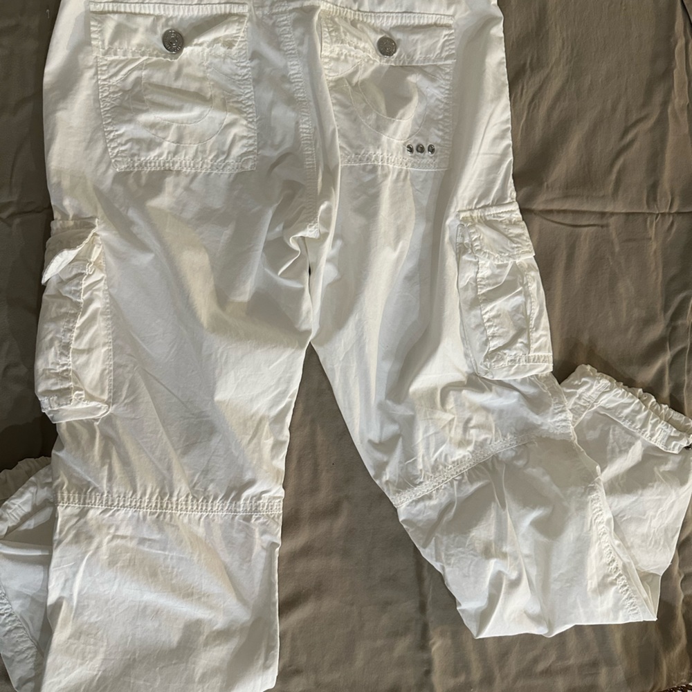 True Religion cargo pants in white with drawstrings on bottom.